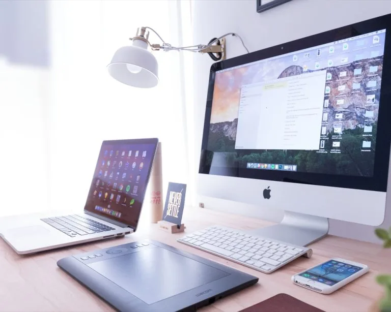 A Zoom call displayed on a laptop screen with multiple participants visible, accompanied by a steaming coffee mug placed nearby, highlighting productivity, virtual teamwork, and casual workplace collaboration.