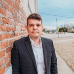 A professional male employee dressed in business attire, confidently representing JF Property Group, showcasing expertise, dedication, and commitment to exceptional real estate service.